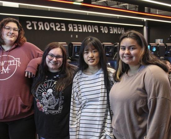 The four members of the first all-female eSports team at 利记sbo stands shoulder to shouler.